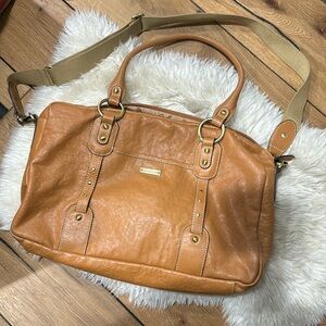 Storksak Elizabeth leather diaper bag with adjustable straps and accessories